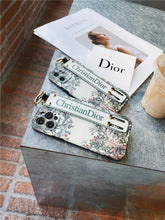 Load image into Gallery viewer, ChristianDior Soft Silicone with Removable Stand Belt&amp;Ring iPhone Cases.